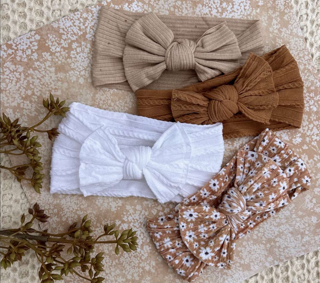 4 bows in a flatlay by bowy lou, with decor and vintage themed items